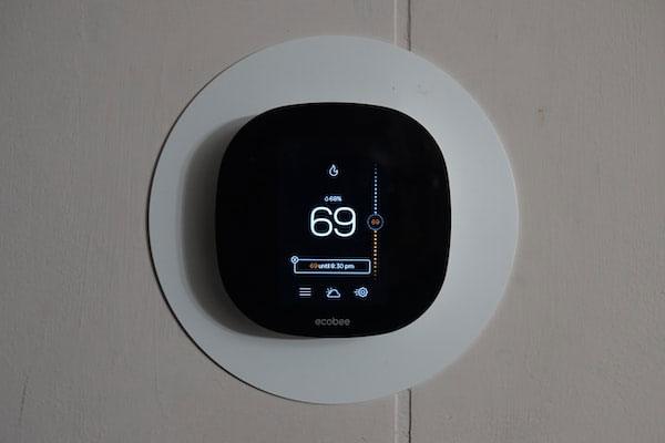 A thermostat displays the temperature in a home and relays heating instructions to the furnace.